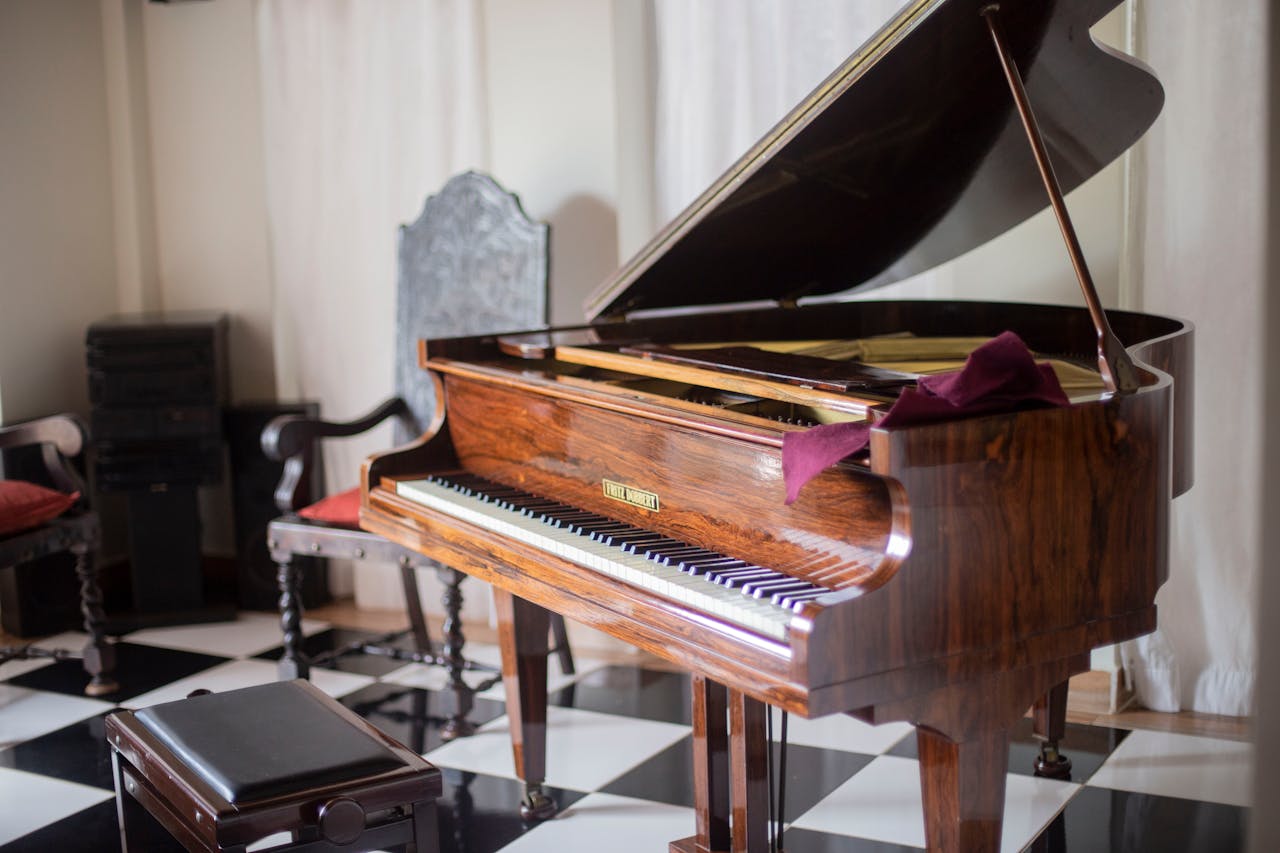 Beautiful wooden grand piano with open lid in a sophisticated room with elegant decor.